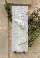 The city of Petra in Mallorca - bas-relief Juníper Serra with juniper branches. Click to enlarge the image.