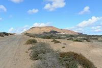 The island of Graciosa to Lanzarote. The volcano of Agujas Grandes. Click to enlarge the image in Adobe Stock (new tab).