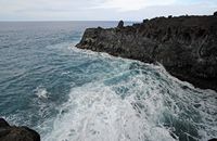 The natural park of los Volcanes in Lanzarote. The Cliffs of Los Hervideros. Click to enlarge the image in Adobe Stock (new tab).