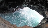 The natural park of los Volcanes in Lanzarote. The Cliffs of Los Hervideros. Click to enlarge the image in Adobe Stock (new tab).