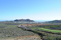The village of Guatiza in Lanzarote. The village and the Las Calderetas volcano. Click to enlarge the image in Adobe Stock (new tab).