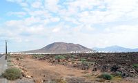 The village of Playa Blanca in Lanzarote. La Montaña Roja view from the lighthouse Peguichera. Click to enlarge the image.